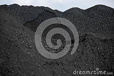 Heaps of coal in the red light Stock Photo