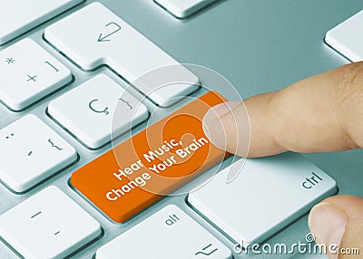 Hear Music, Change Your Brain - Inscription on Orange Keyboard Key Stock Photo