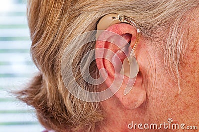 Hearing aid in the ear Stock Photo