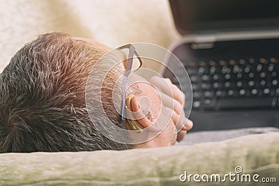 Hearing impaired man using laptop Stock Photo