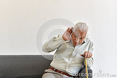 Hearing loss problem, Asian old man with hand on ears gesture trying to listen. Stock Photo