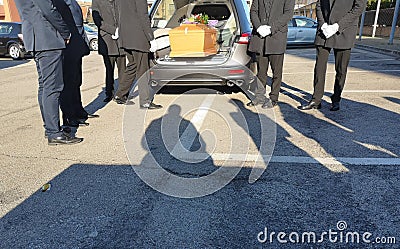Hearse with coffin and gravediggers Stock Photo