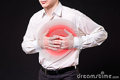 Heart attack, man with chest pain on black background Stock Photo