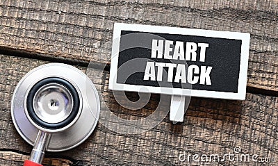 HEART ATTACK on a small chalkboard next to a stethoscope Stock Photo