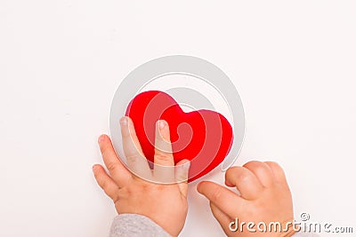 Heart in babys hand isolated on white background, copy space Stock Photo