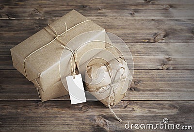 Heart and box wrapped in brown kraft paper with a price tag, on Stock Photo