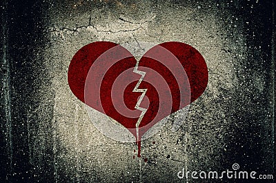 Heart broken painted on grunge cement wall background - love con Stock Photo