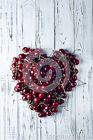 Heart of cherries. From cherries lined with a big heart. Stock Photo