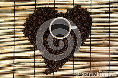 Heart from coffee beans with coffee cup on japan mat Stock Photo