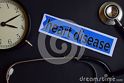 Heart Disease on the print paper with Healthcare Concept Inspiration. alarm clock, Black stethoscope. Stock Photo