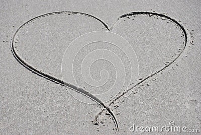 Heart drawn in the sand Stock Photo