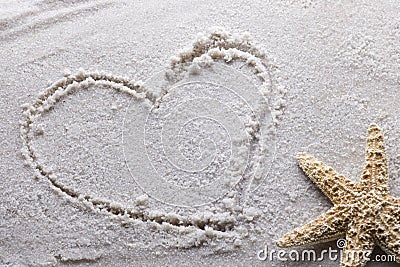 Heart drawn in sand Stock Photo