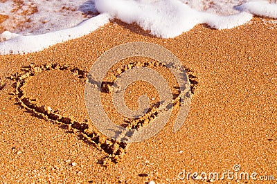 Heart drawn on sand Stock Photo