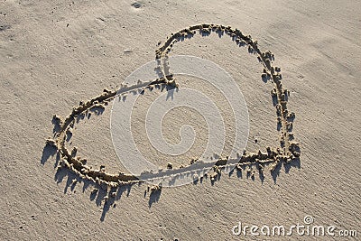 A heart drawn in the sand Stock Photo