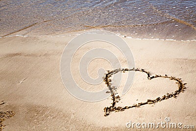 Heart drawn in sand with copy space Stock Photo