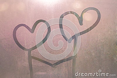 Handwritten heart on a steamy glass. Stock Photo