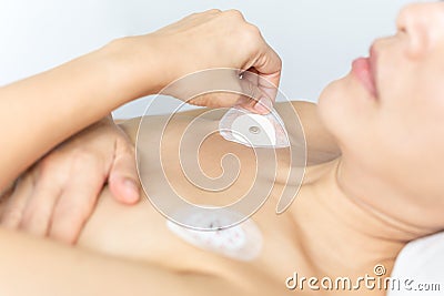 Heart electrocardiogram or monitoring using Holter for woman patient. Stock Photo