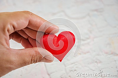 Heart on hand for philanthropy concept / woman holding red heart in hands for valentines day or donate help give love warmth take Stock Photo