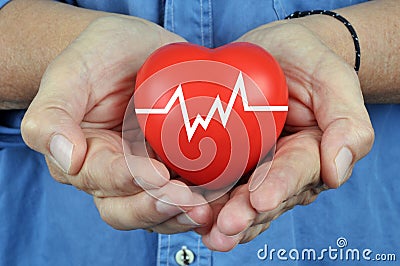 Heart in hands with a curve close up Stock Photo