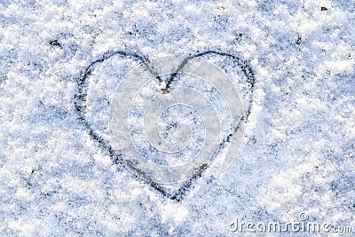 Heart handwritten on snow. Love symbol in winter Stock Photo