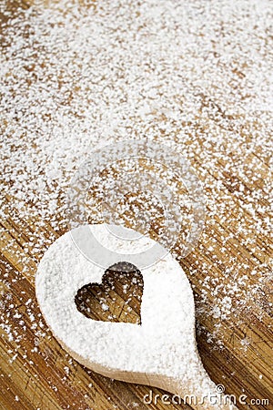Heart hole spoon on the wooden pastry board Stock Photo