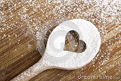 Heart hole spoon on the wooden pastry board Stock Photo