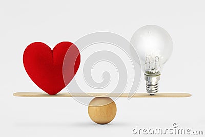 Heart and light bulb on scale - Concept of balance between heart and brain Stock Photo