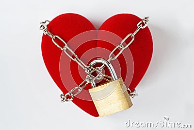 Heart locked with chain and padlock on white background - Concept of love Stock Photo