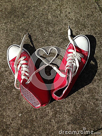 Heart Love shape symbol with sneakers teen baseball urban `teen love` or healthy heart exercise concept red boots with laces heart Stock Photo