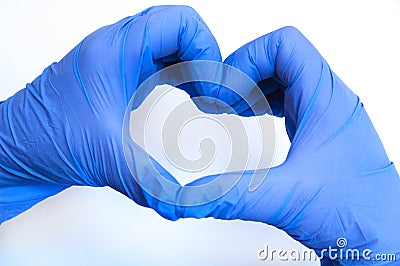 Heart made of blue gloves on a white background. gloved hands Stock Photo