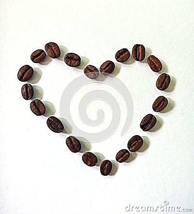 Heart made from coffee beans on white background. Coffee love , sybmol, wallpaper Stock Photo