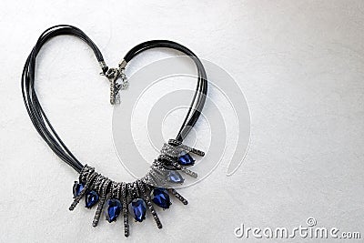 Heart made of female jewelry, necklaces with blue gems, diamonds, diamonds in the shape of a heart Stock Photo