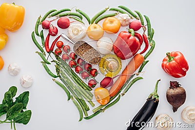 heart made of green peas and fresh ripe vegetables with spices Stock Photo