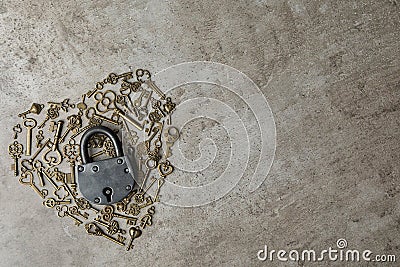 Heart made of keys, steel padlock and space for text on stone background, top view. Safety concept Stock Photo