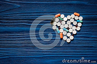 Heart made of pills on blue wooden table background top view copyspace Stock Photo