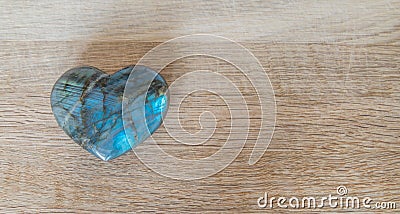 Heart made of precious stone on wood Stock Photo