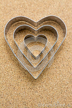 Heart, metal shape on pressed corkwood background. Conceptual photo Stock Photo