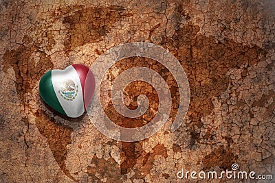 Heart with national flag of mexico on a vintage world map crack paper background. Stock Photo