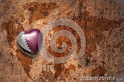 Heart with national flag of qatar on a vintage world map crack paper background. Stock Photo