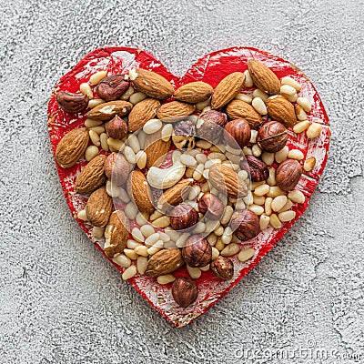 Heart with nuts on a gray background Stock Photo