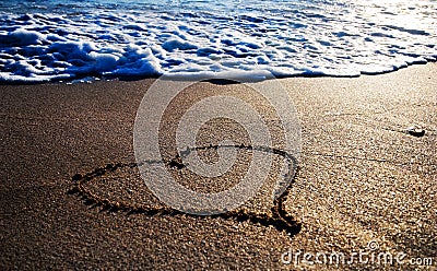 Heart outline on the wet sand Stock Photo