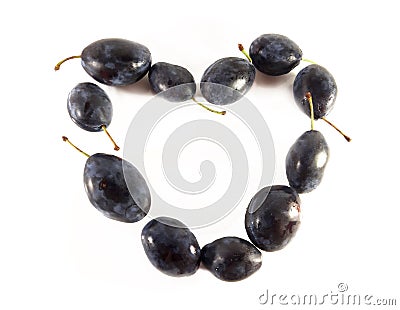 Heart of plum, frame. Fruit on white background. Juicy dessert. Diet vegetarian food, photo Stock Photo