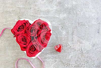 Heart of red roses on grey background with ribbon Stock Photo