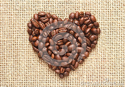 Heart shape coffee beans on sacking Stock Photo