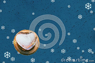 Heart shape ice and water drop or rain on mirror and snow blue b Stock Photo