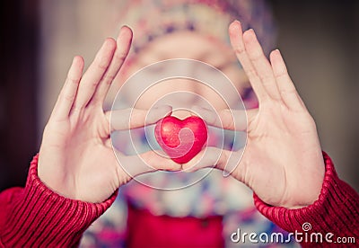 Heart shape love symbol in woman hands Stock Photo