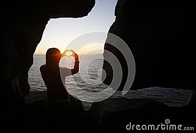 Heart shape made with a girl hands Stock Photo