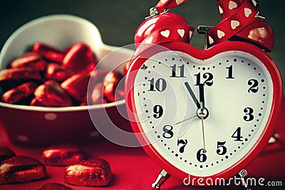 Heart shape red love clock and chocolated Stock Photo