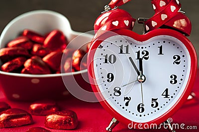 Heart shape red love clock and chocolates Stock Photo