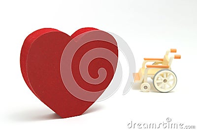 Heart shape and wheelchair on white background. Stock Photo